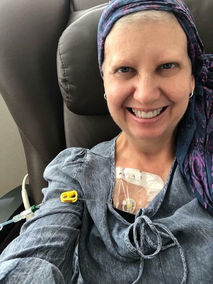 Kathy Jennings takes a selfie as she receives an infusion.
