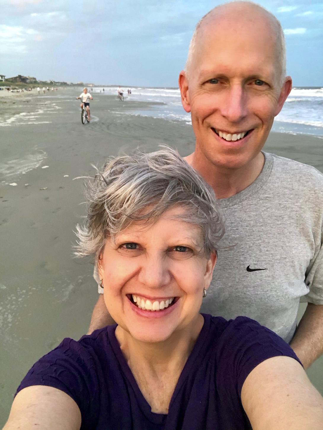 Kathy Jennings and her husband Spencer smile in a selfie on a beach in South Carolina.