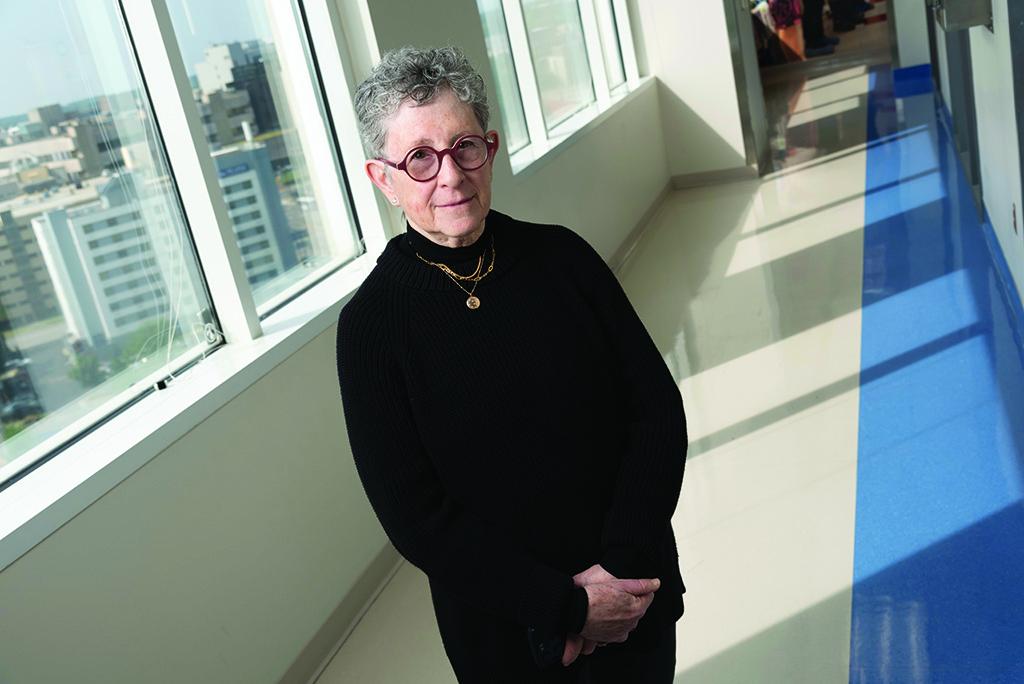 Joanne Kurtzberg, MD, in front of windows and a long hallway