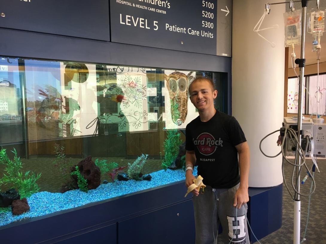 Bobby Menges stands in front of an aquarium at Duke