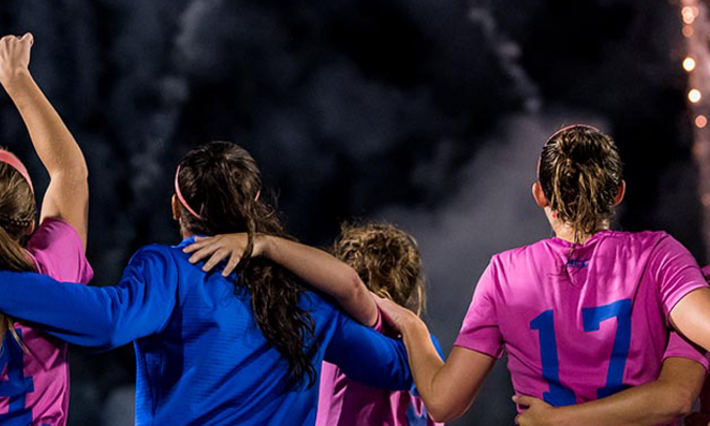 Duke Women's Soccer players link arms during the Kick Cancer Soccer Game.