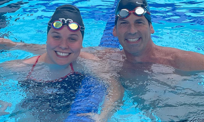 Morgan Stickney and William Eward, MD celebrate their race in the pool.