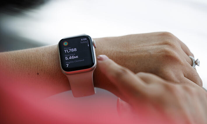 A wrist wearing an activity-tracking watch.