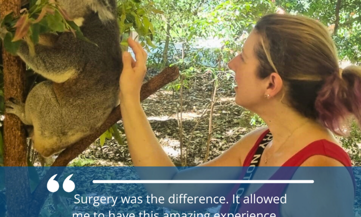A woman reaches out toward a koala in a tree. "Surgery was the difference. It allowed me to have this amazing experience ... It wouldn't have been possible without the team at Duke." Heather Moffitt.