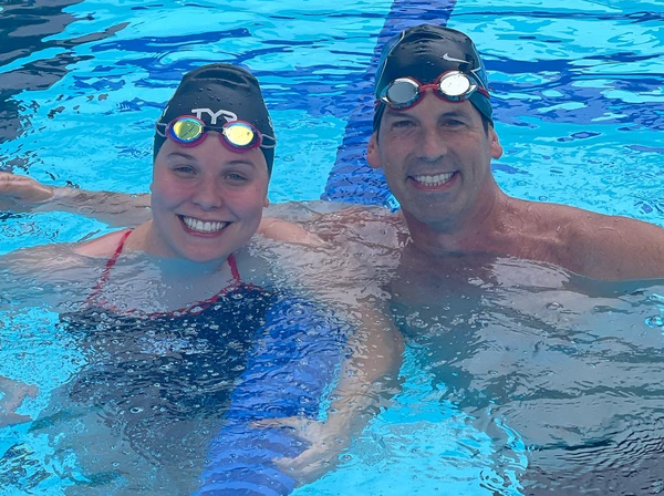 Morgan Stickney and William Eward, MD celebrate their race in the pool.