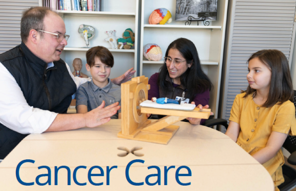 A father and child life therapist work with his children on the cover of the April 2024 Cancer Care Calendar.