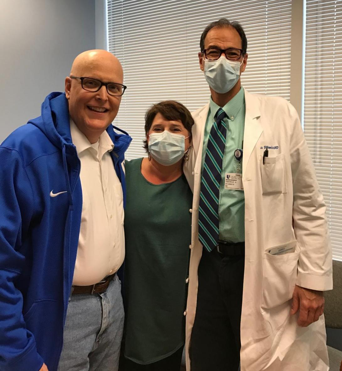 Scott Balderson standing with his wife and Thomas D’Amico in hospital