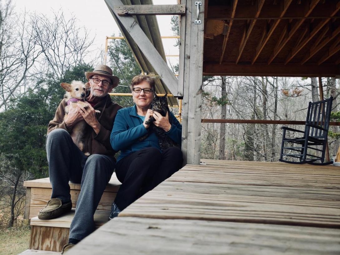 Tom Dinwiddie and his wife Diane hold their rescue pets outside their home.