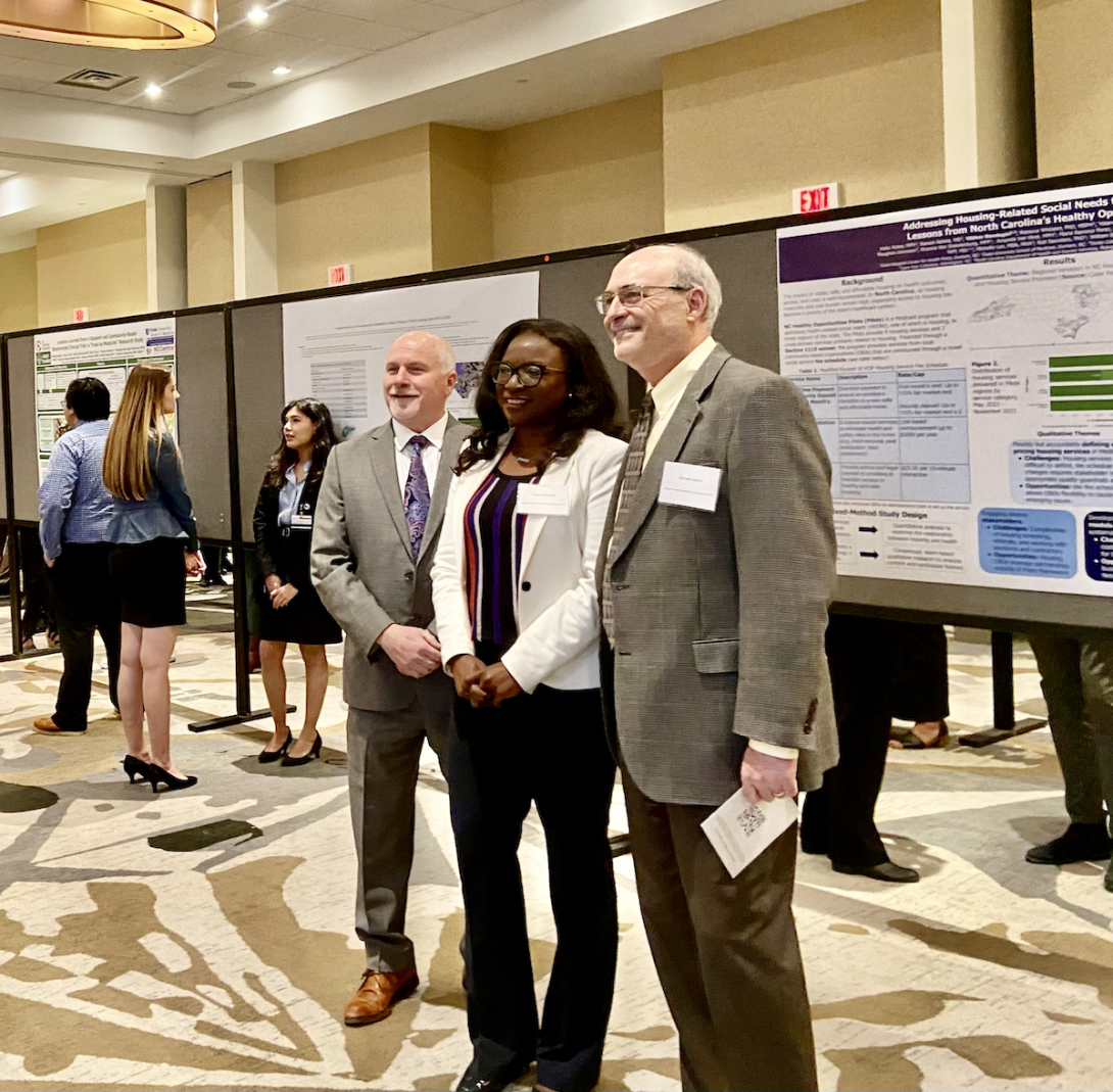 Steven Patierno, Tomi Akinyemiju, and Michael Kastan, pose at the symposium poster session