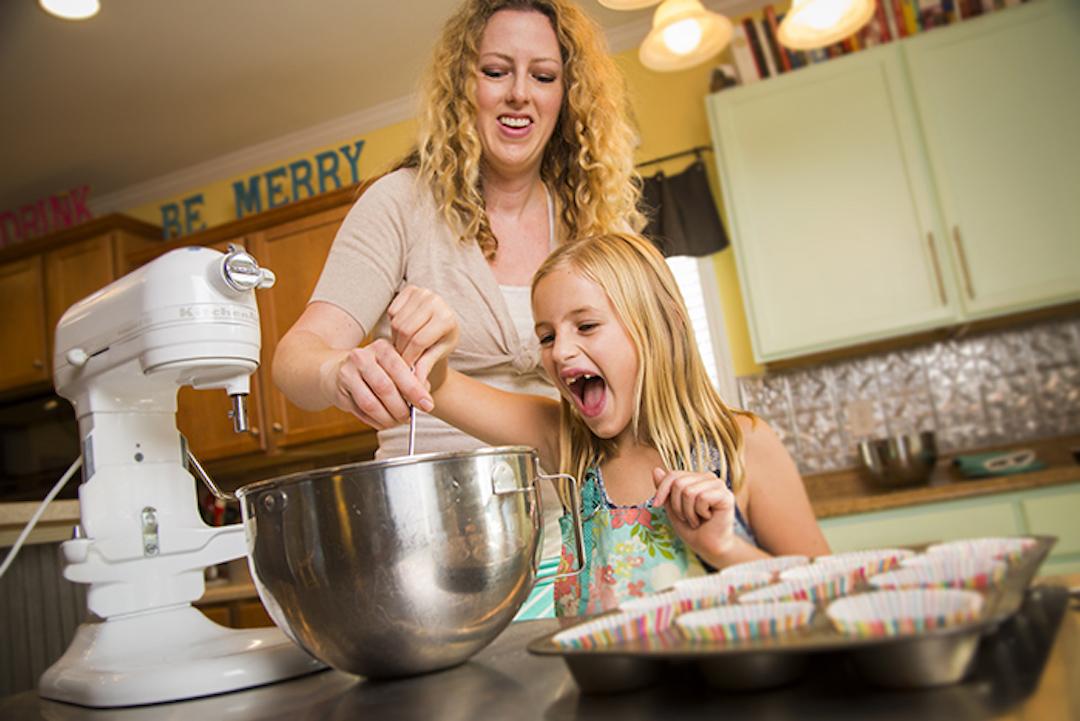 Young cancer survivor Eve Griffith bakes with her mother. 